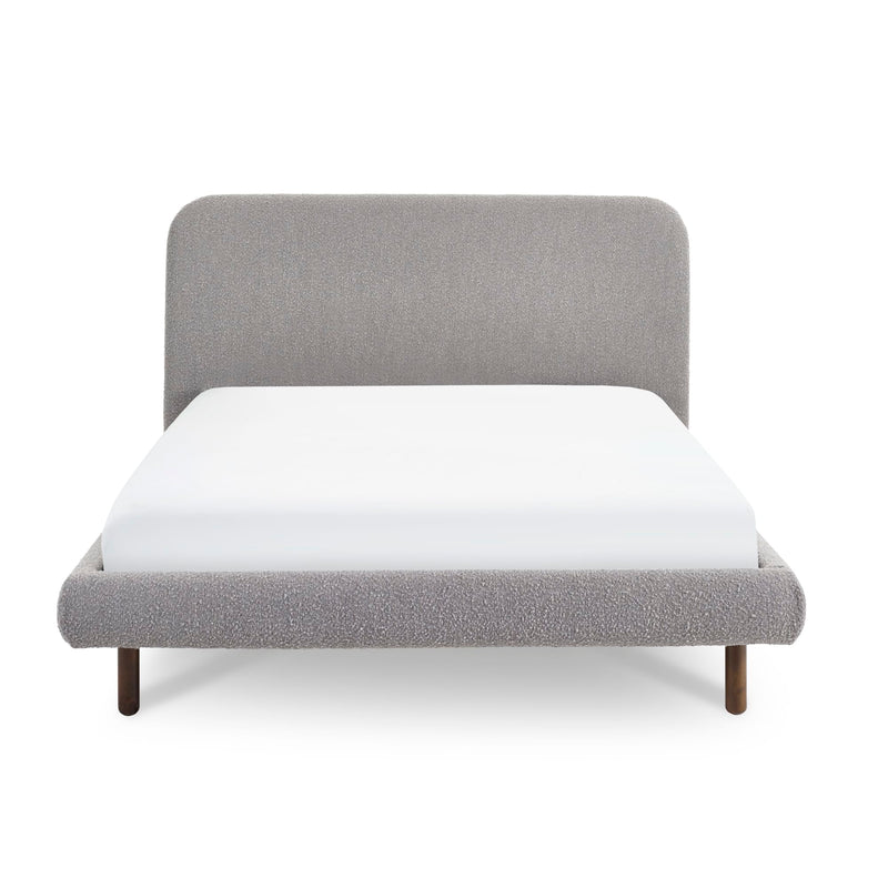 Gray upholstered bed with white mattress on a white background