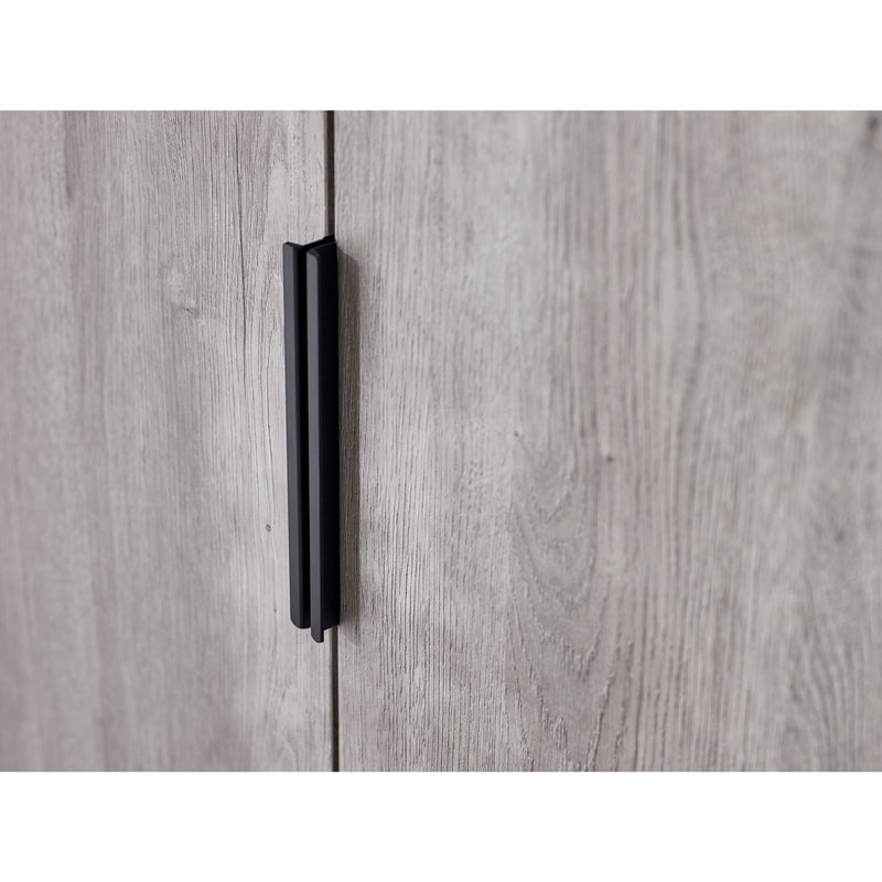 Close-up of a wooden cabinet with a black handle on a white background