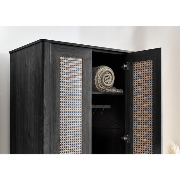 Black wardrobe with open door revealing a rolled-up towel inside, on a white background