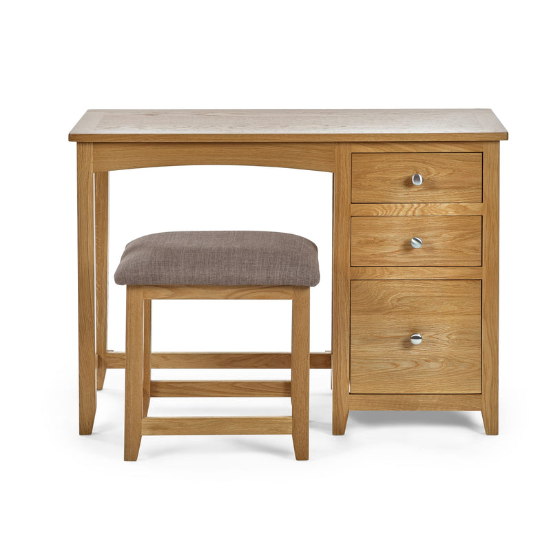 Wooden desk with three drawers and a matching stool on a white background