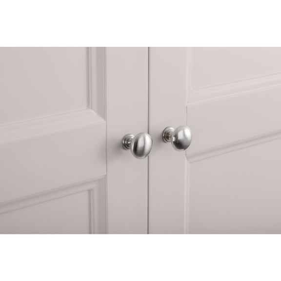 Close-up of a light gray cabinet with silver knobs on a white background
