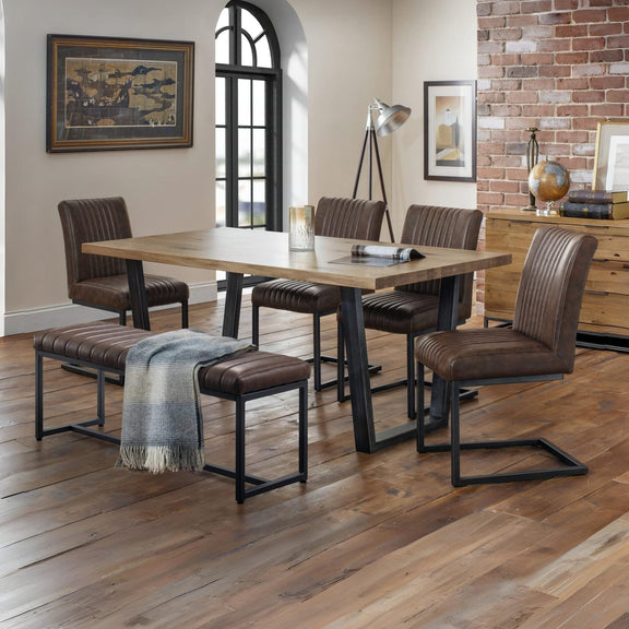Dining room with wooden table and chairs on a wooden floor.