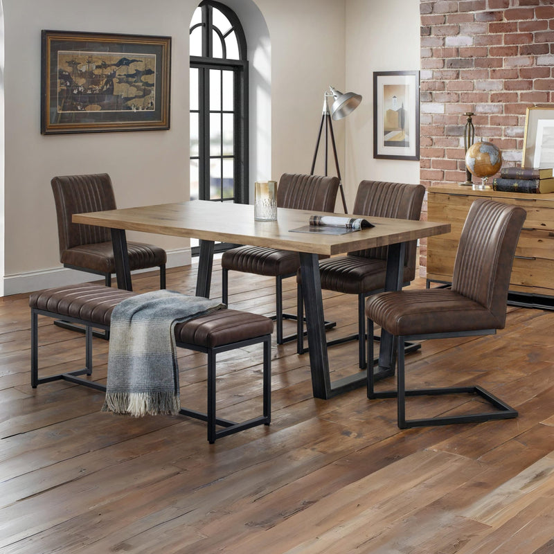 Dining room with wooden table and chairs on a wooden floor.