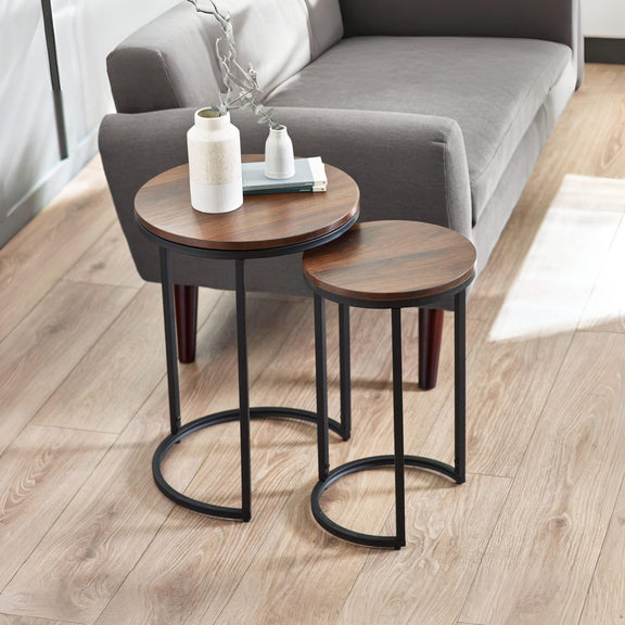Two wooden side tables with black metal legs in a living room setting.