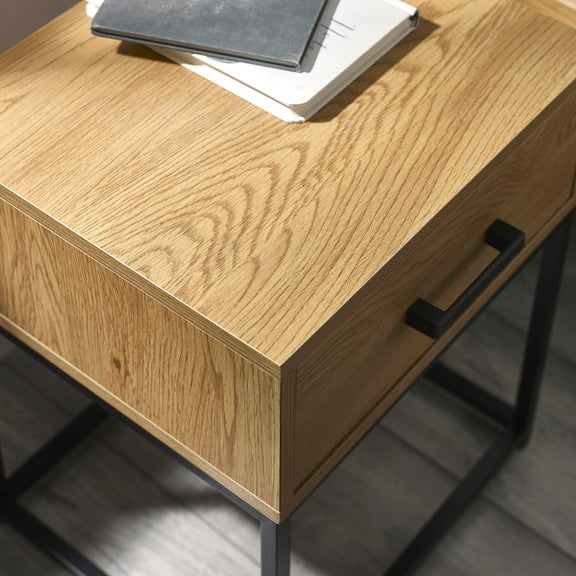 Wooden desk with black metal legs and handles on a gray background