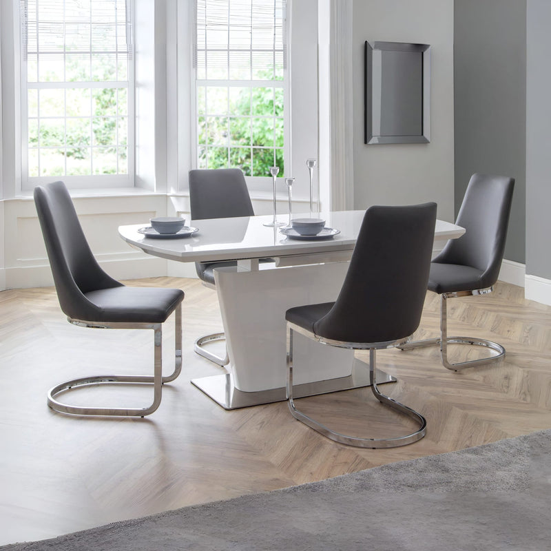 Modern dining room with a glass table and black chairs.