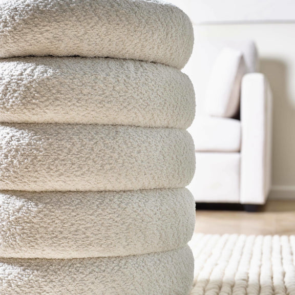 Stack of beige towels on a blurred indoor background