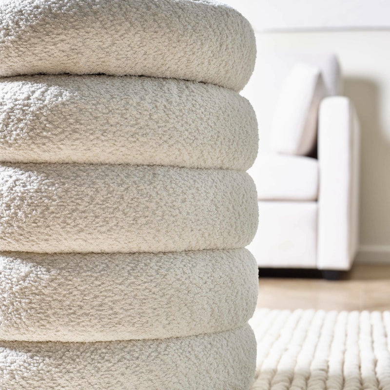 Stack of beige towels on a blurred indoor background
