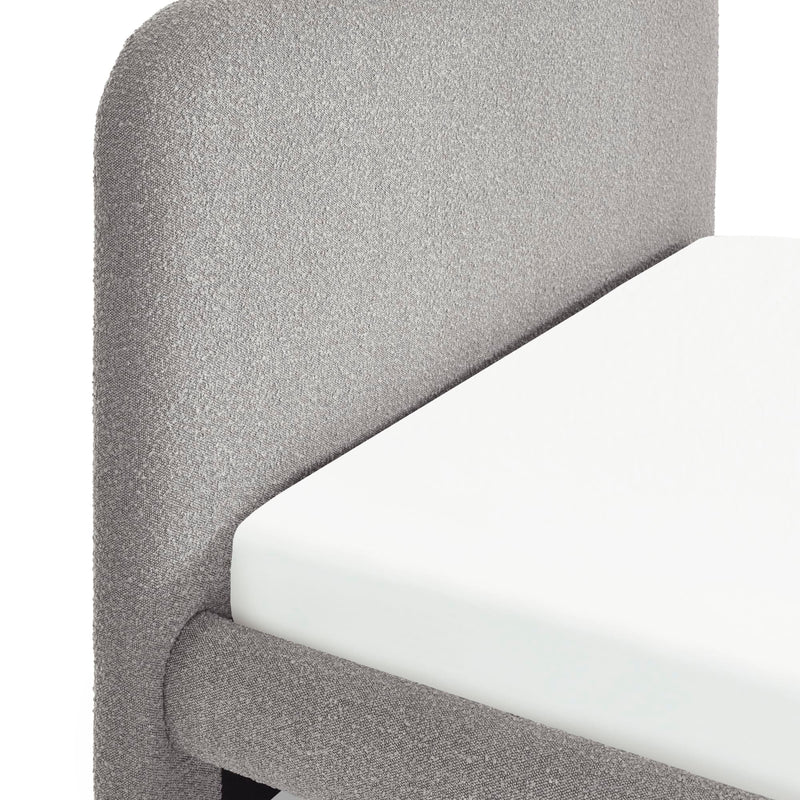Gray upholstered chair with white cushioned seat on a plain background