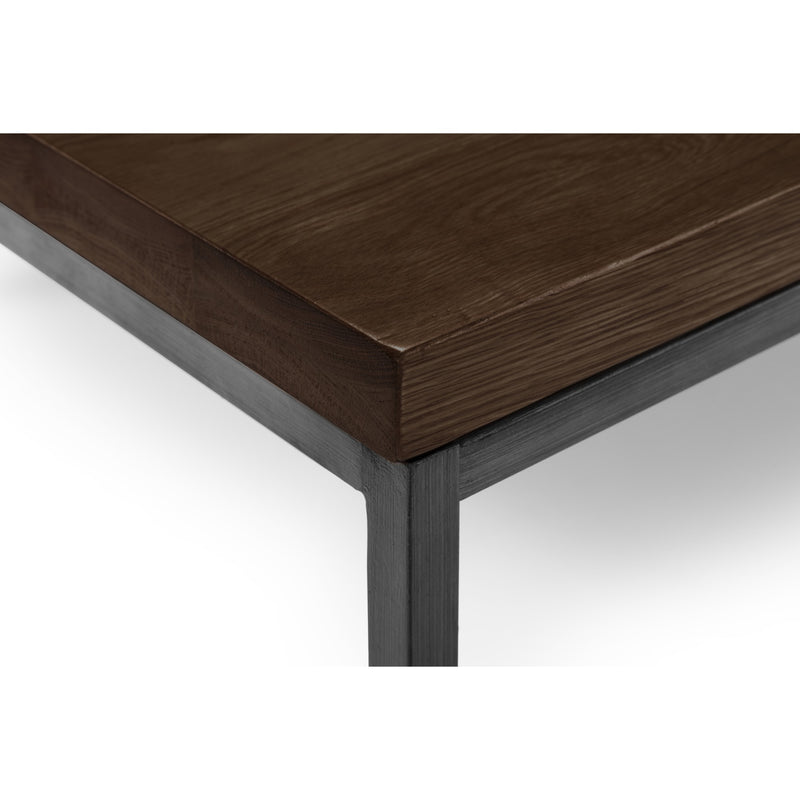 Wooden table corner with dark brown surface and metal frame on a white background