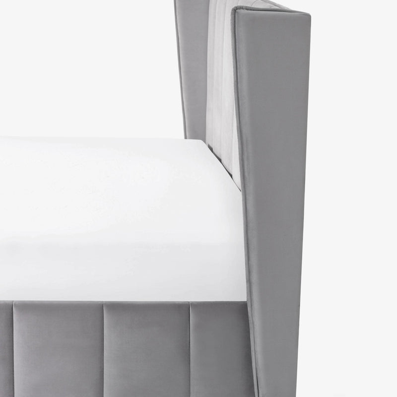 Gray upholstered chair with a white cushion on a light gray background