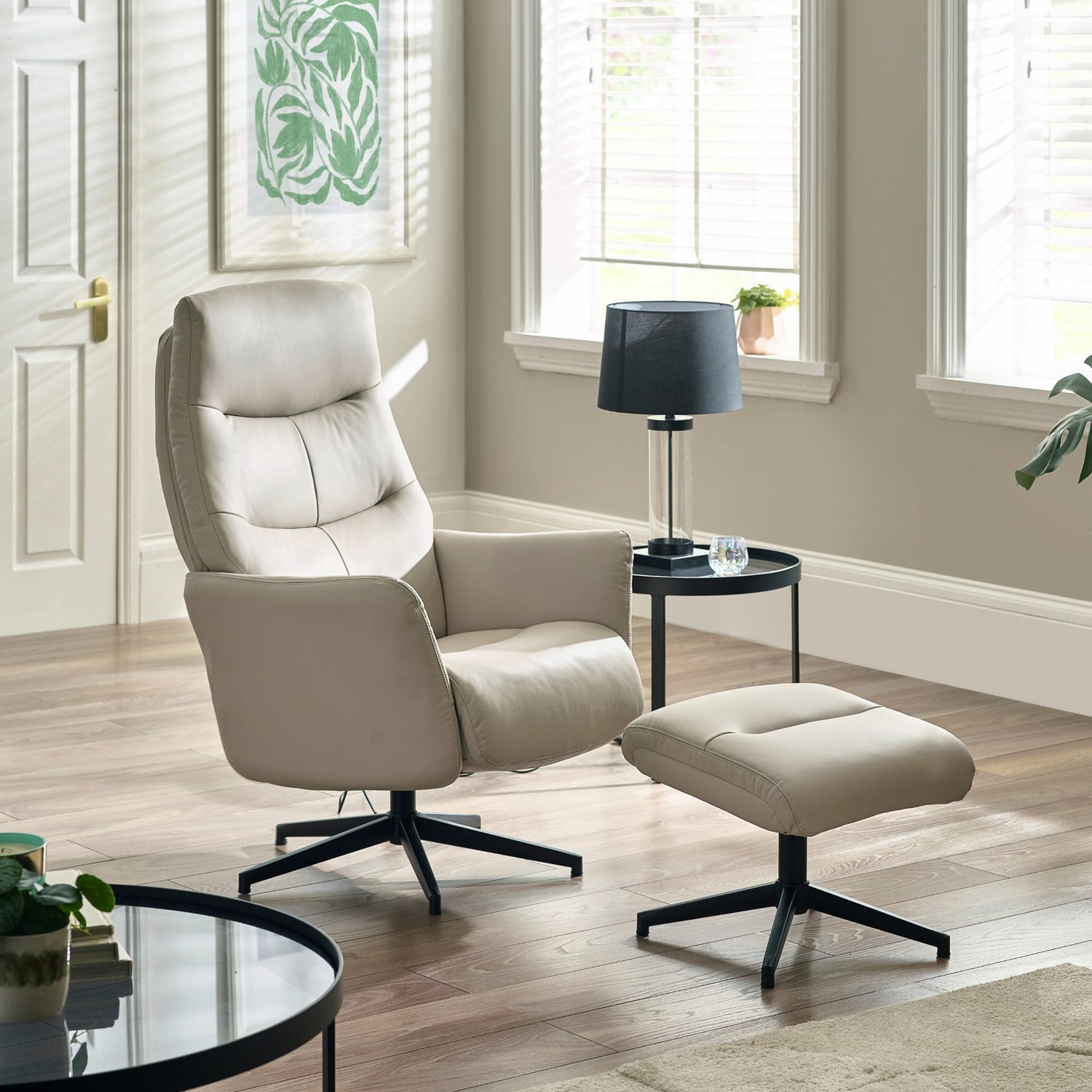 Beige armchair with ottoman in a living room setting