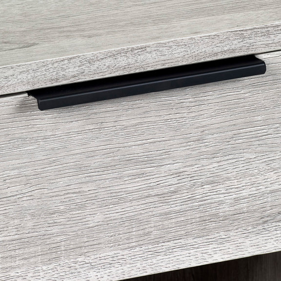 Close-up of a black cabinet handle on a gray wooden surface