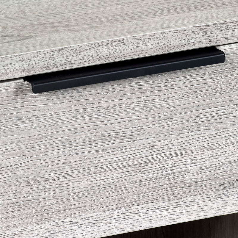Close-up of a black cabinet handle on a gray wooden surface