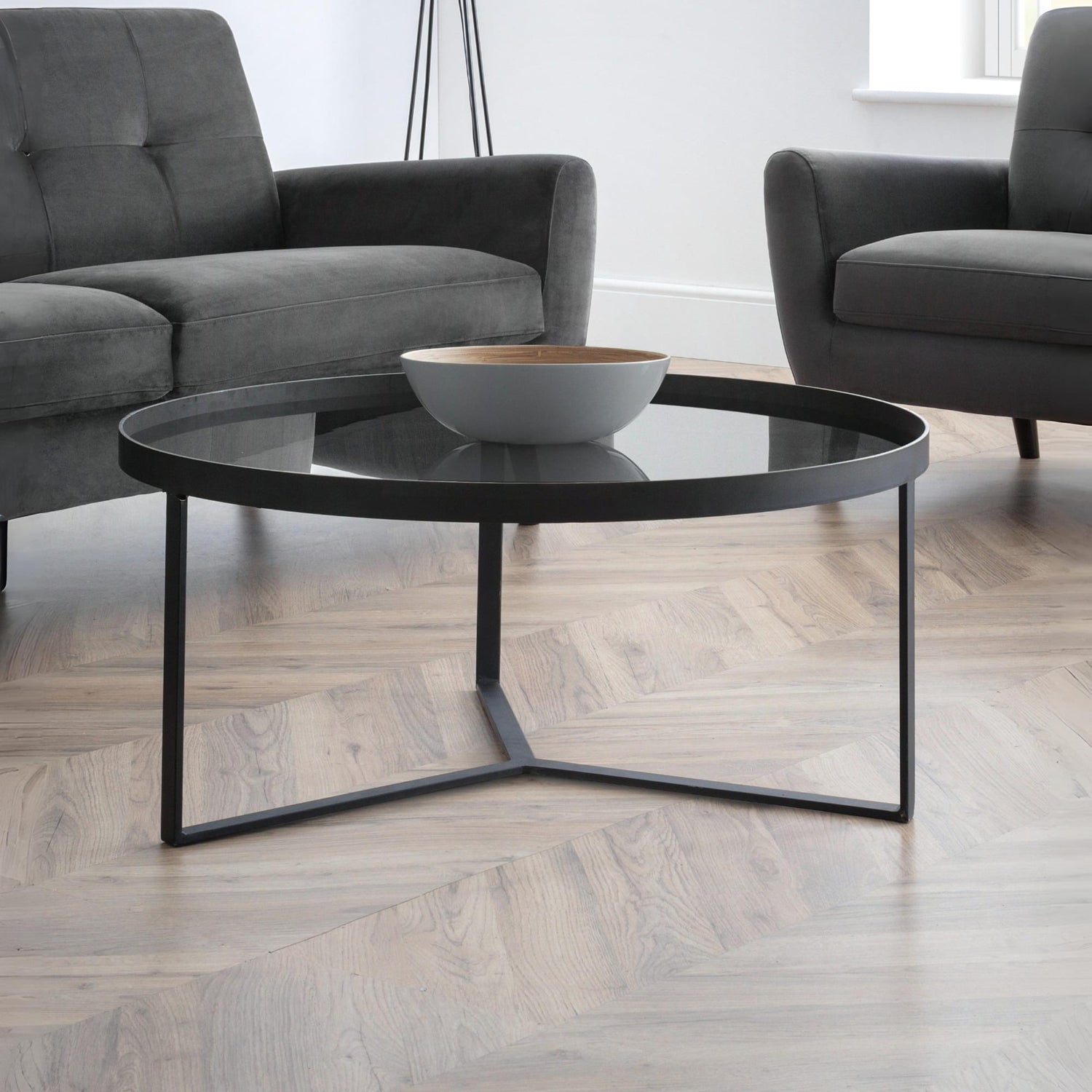 Modern living room with a black coffee table and gray sofa.