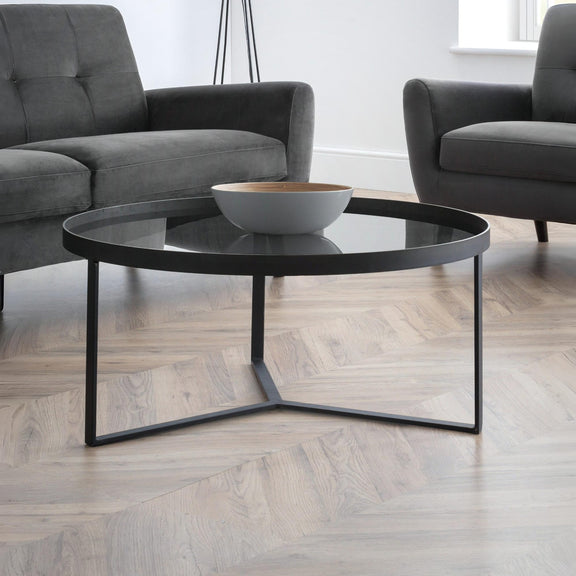 Modern living room with a black coffee table and gray sofa.