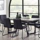Dining table with chairs in a modern room with large windows