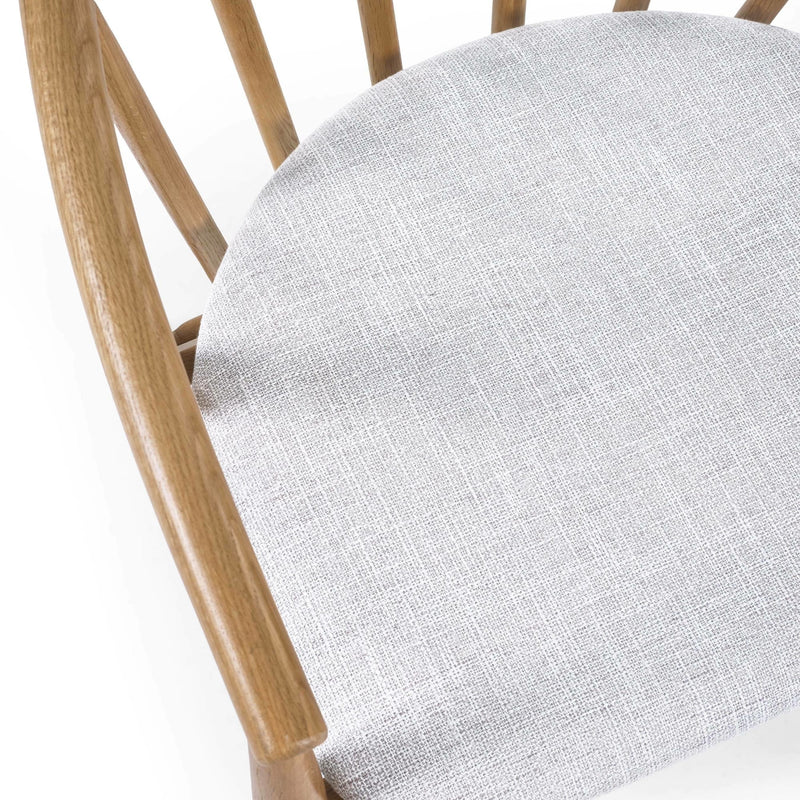 Close-up of a chair with a wooden frame and gray cushion on a white background