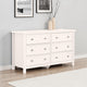White dresser with six drawers in a room with light gray walls and a white rug.