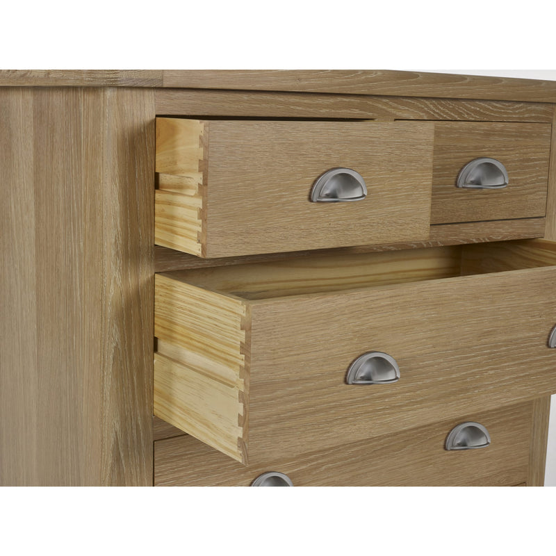 Wooden dresser with two drawers and metal handles on a white background