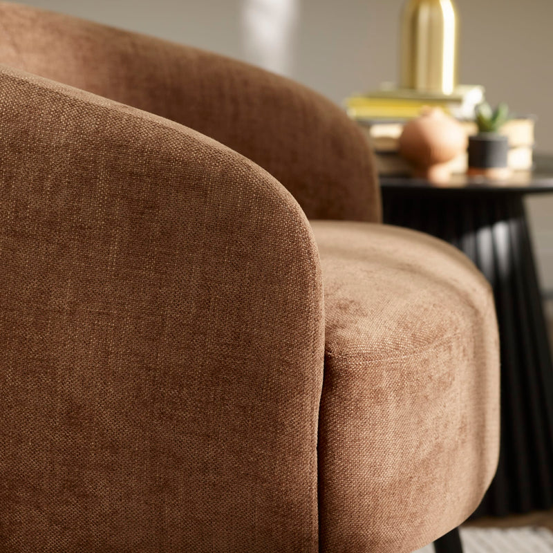Brown upholstered chair with a blurred background