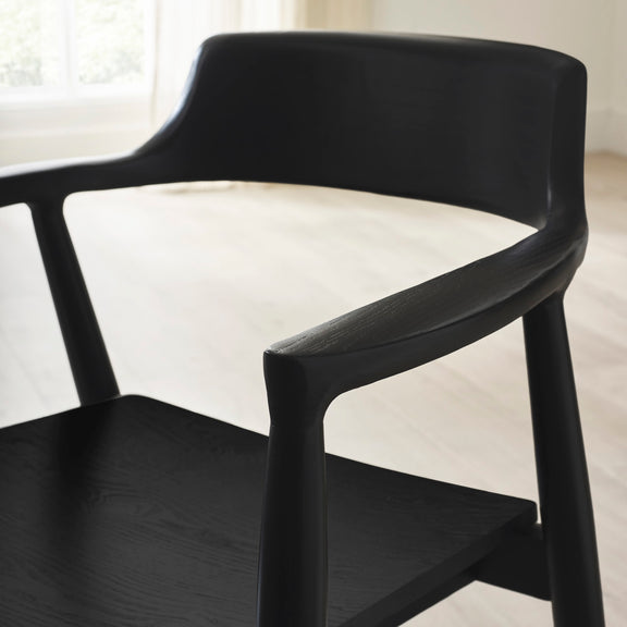 Black chair with a white cushion on a blurred background