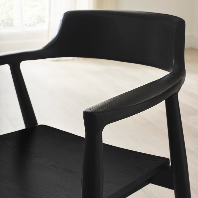 Black chair with a white cushion on a blurred background