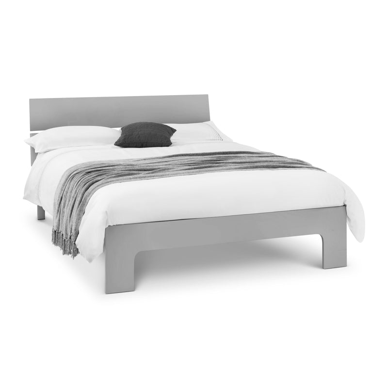 Gray bed frame with white bedding and a gray blanket on a white background
