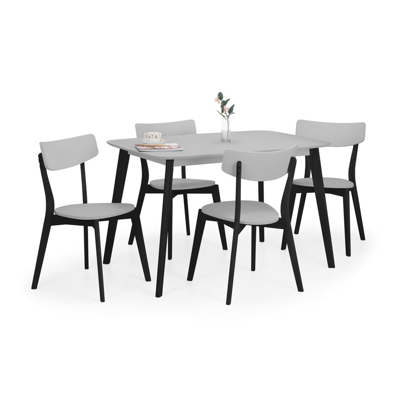 Dining table set with four chairs on a white background