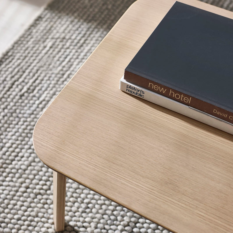 Wooden table with books on a textured surface