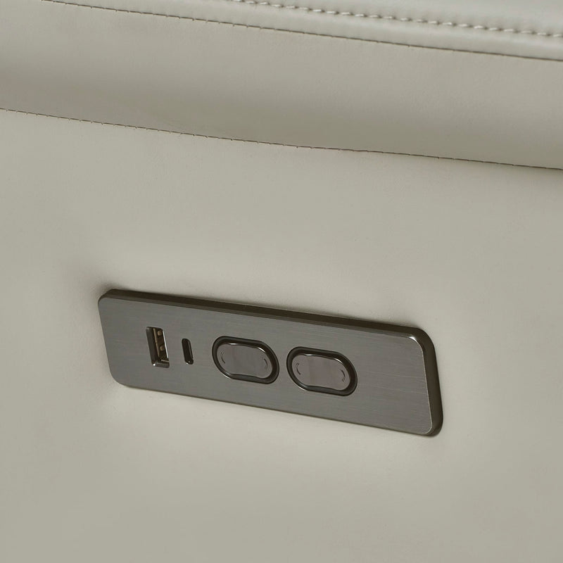 Close-up of a power outlet with USB port and two sockets on a beige wall.