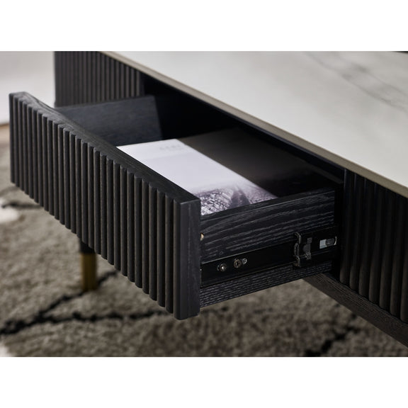 Black wooden drawer with a white shirt inside, on a light-colored surface.