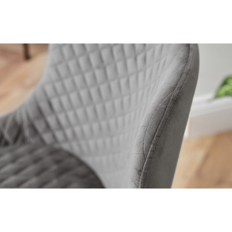 Close-up of a textured gray chair with a blurred background