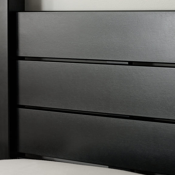 Close-up of a dark gray metal drawer with horizontal slats.