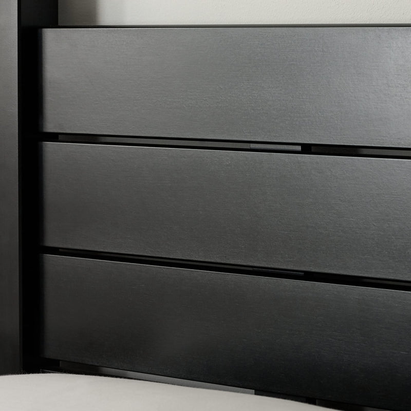 Close-up of a dark gray metal drawer with horizontal slats.