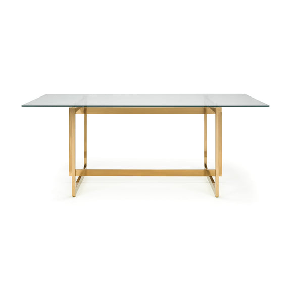 Table with glass top and gold metal frame on a white background