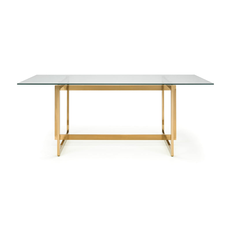 Table with glass top and gold metal frame on a white background