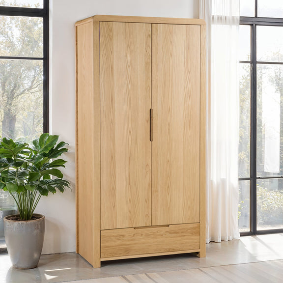 Wooden wardrobe with a plant in a room with large windows