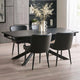 Dining room with a black dining table and chairs in a modern interior setting.