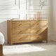 Wooden dresser with four drawers in a bedroom setting