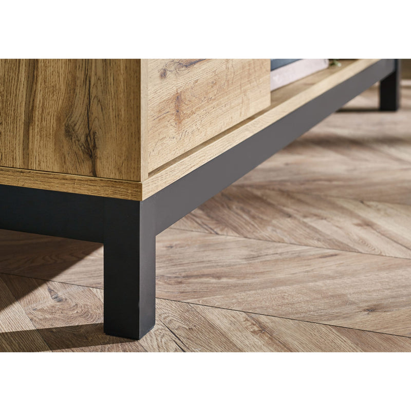 Wooden table with black metal legs on a wooden floor