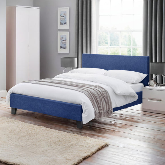 Modern bedroom with a blue bed frame, white bedding, and gray walls.
