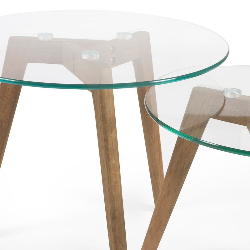 Glass top table with wooden legs on a white background