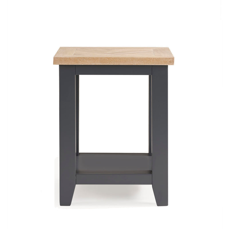 Small table with a wooden top and dark gray base on a white background