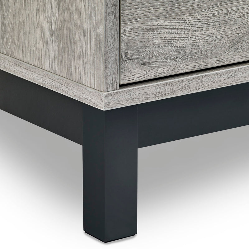 Close-up of a wooden cabinet with a black metal leg on a white background