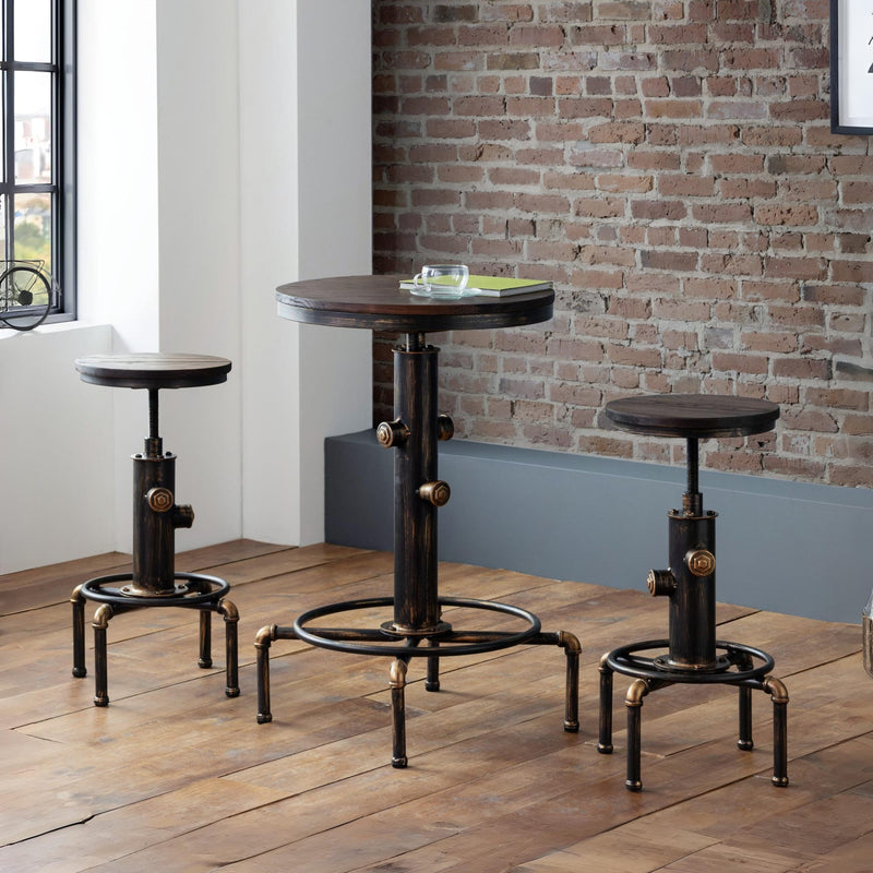 Set of industrial-style stools and a small round table against a brick wall.