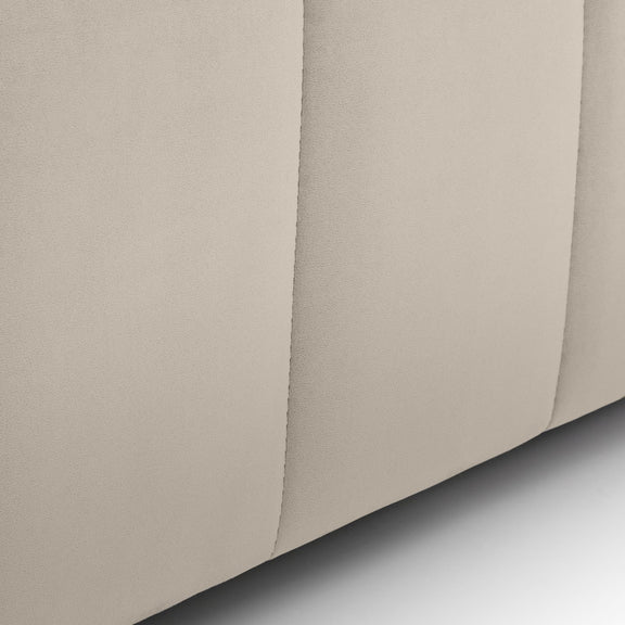 Close-up of beige fabric with a subtle texture on a light gray background