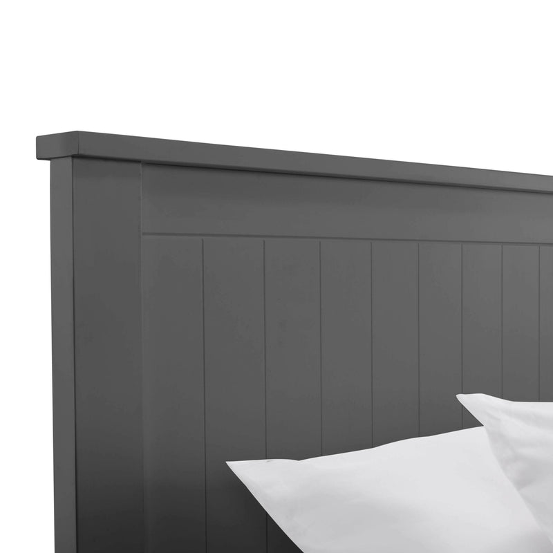 Gray wooden headboard with white pillows on a light gray background