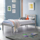Children's bedroom with a bed, toys, and colorful bedding against a blue wall.