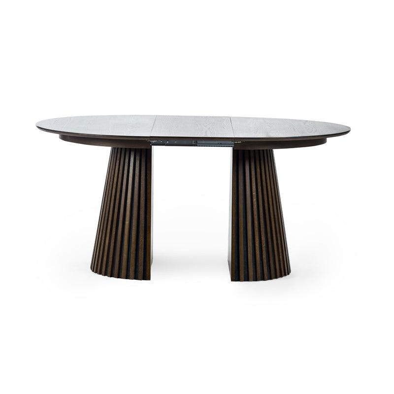 Round dining table with dark wood base on a white background